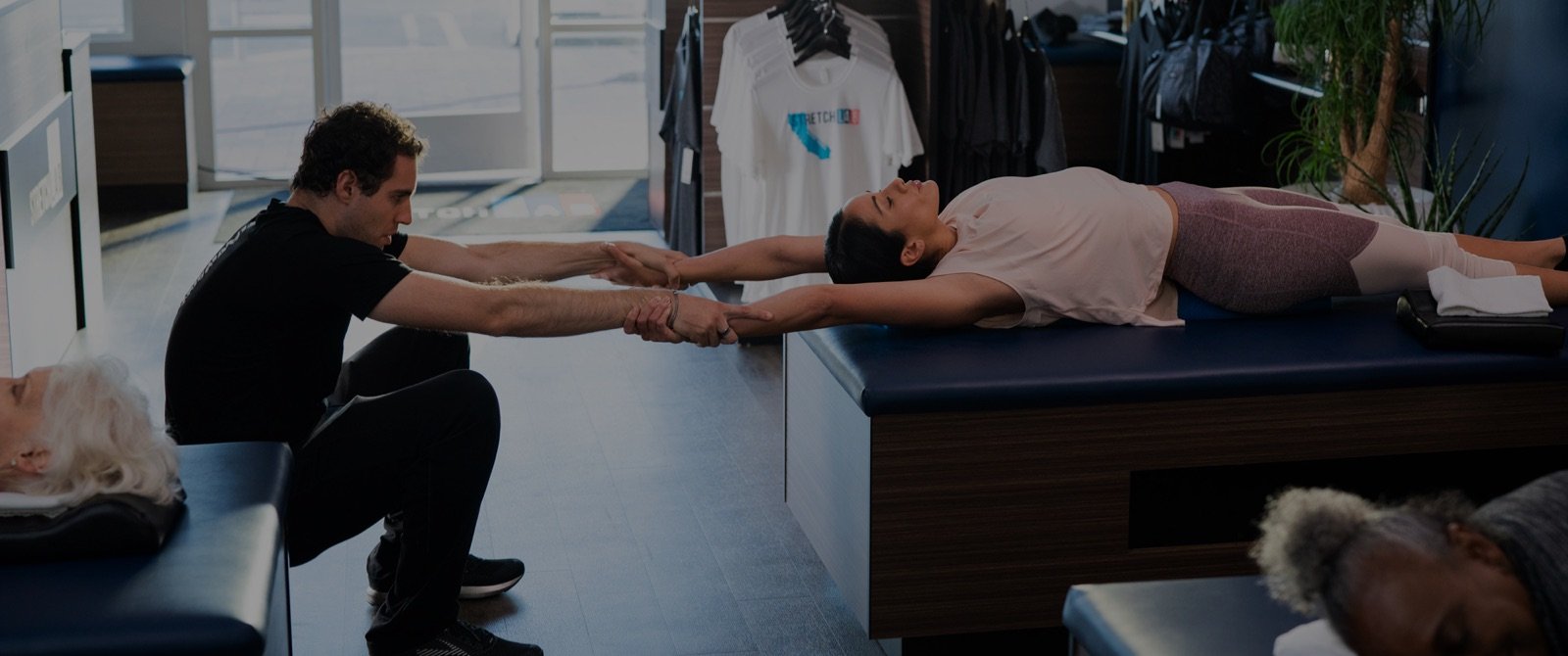 Flexologist assisting person with stretch