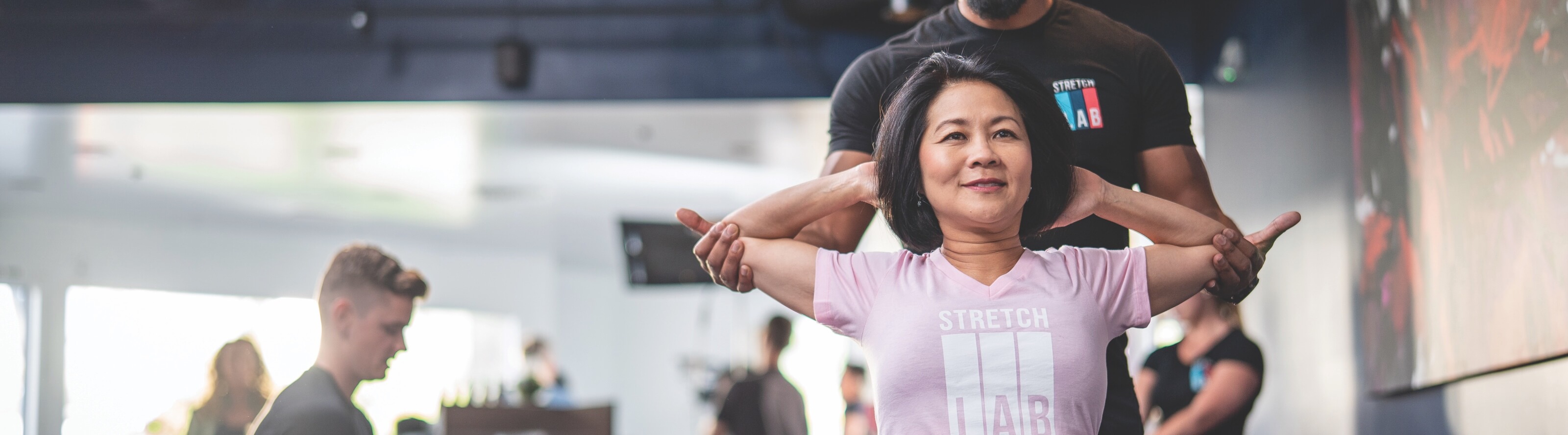 Flexologist assisting person with stretch