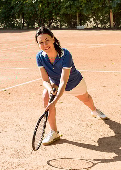 female tennis player on dirt court